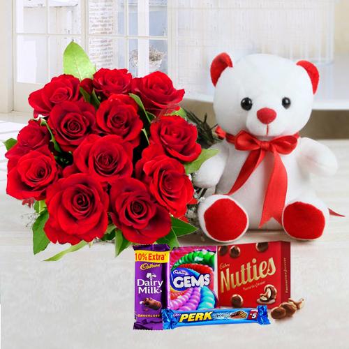 Impressive 12 Red Roses bouquet with attractive Teddy and miscellaneous Cadburys Chocolate